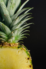 sliced pineapple fruit closeup on black background - 162773151