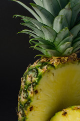 sliced pineapple fruit closeup on black background - 162773181