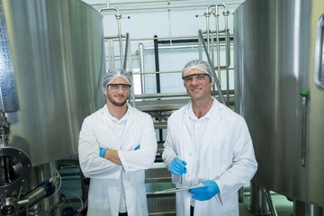 Obraz premium Portrait of scientists standing by storage tank