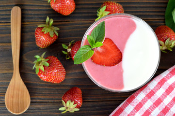 Strawberry yogurt on wooden table