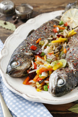 Rainbow trouts with cut vegetables.