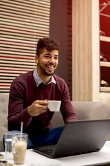 Businessman in a cafe and drink coffee.