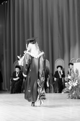 Fototapeta premium A graduate of the university in a traditional academic mantle at the solemn ceremony of awarding diplomas