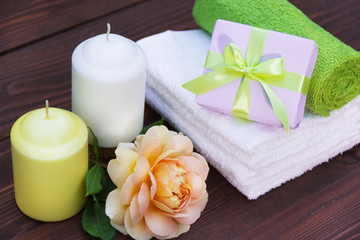 Fragrant candles, soft towels, flowers and presents. Romantic concept. Spa concept.