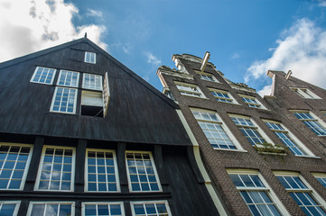 Fototapeta na wymiar Amsterdam typical houses fronts under a clody sky