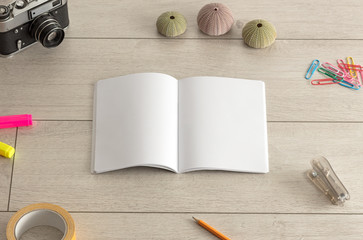 Notebook on the floor with office tools nearby