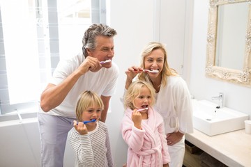 Family brushing teeth together in the bathroom