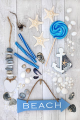 Abstract design with beach sign, seashells, pearls, decorative seaside objects, driftwood and rock...