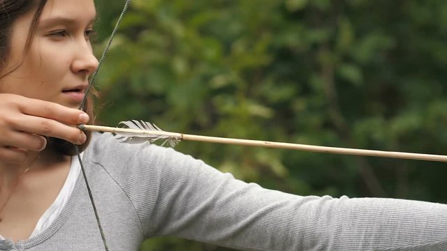 Woman shoots an arrow and satisfied of result