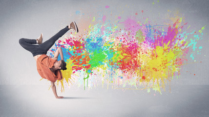 Obraz na płótnie Canvas Young colorful street dancer with paint splash