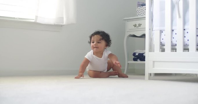Baby Sitting Then Crawls Toward with Smile. Baby sitting and smiling at camera and then crawls toward the camera in slow motion
