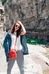 Girl standing near a rock wall