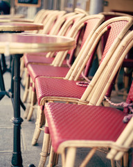 Fototapeta na wymiar Chairs and tables of an outdoors cafe in Paris