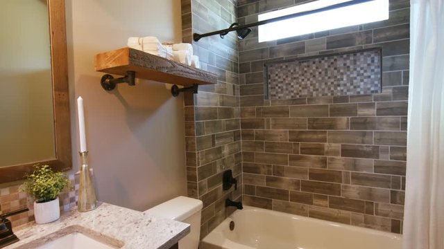 Small Modern Bathroom Rise Up from Floor. shot rises from the doorway of a nice new modern bathroom with tan style

