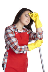 Portrait of a tired housewife leaning against a mop. Standing in rubber gloves isolated on white background