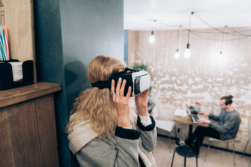 Young girl getting experience VR headset