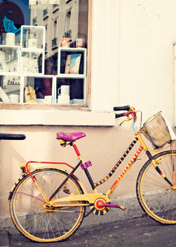 Vintage yellow bicycle in a sidewalk in Paris