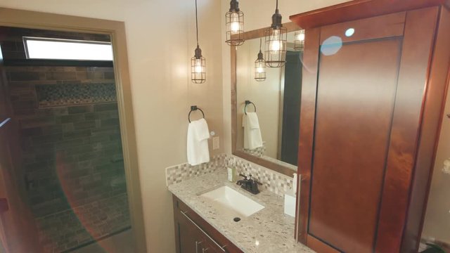 Corner of Double Sink Bathroom Modern Sun Flare Lowering. shot lowers on corner of tight master bathroom corner with entrance to shower
