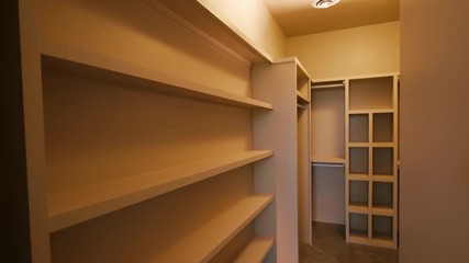 Master Closet Sliding Door Open Reveal. large empty walk in closet is revealed by opening sliding barn door
