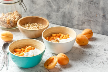 Homemade yogurt with granola, apricot and pine nuts