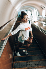 Beautiful young girl on escalator