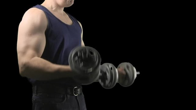 Man wearing tank top stands doing arm curls with dumbbells during weight lifting routine.  Green screen pre-keyed isolated on transparent background alpha channel.