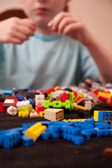 Colorful blocks or toys in foreground, child in background