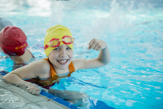 Happy Children Kids Group At Swimming Pool Class Learning To Swim