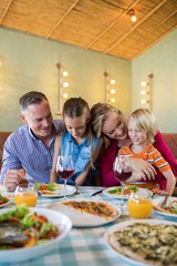 Happy family enjoying dinner at restaurant