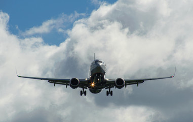 The plane on a background of blue sky and white clouds.