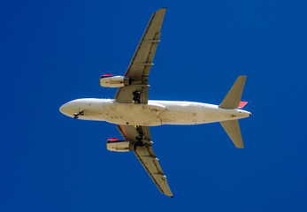 The plane on a background of blue sky and white clouds.