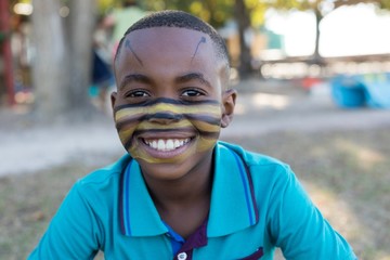 Portrait of smiling boy with face paint - Powered by Adobe