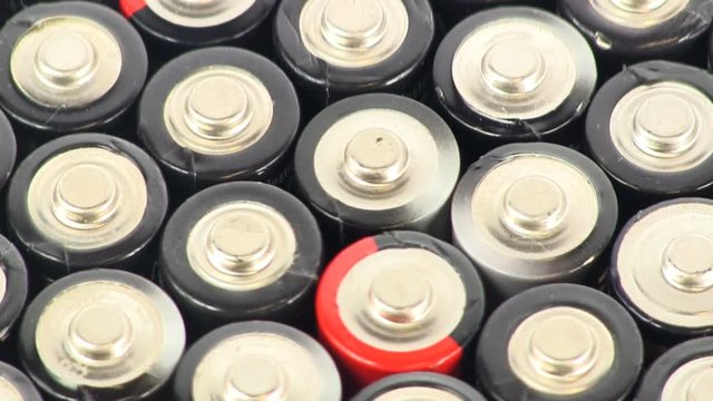 Pan from top to bottom of pile of batteries stacked together