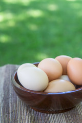 Bowl of fresh cage free eggs on outdoor table