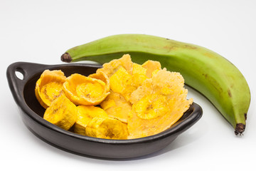 Raw plantain cups, patacones and pieces on white background © anamejia18