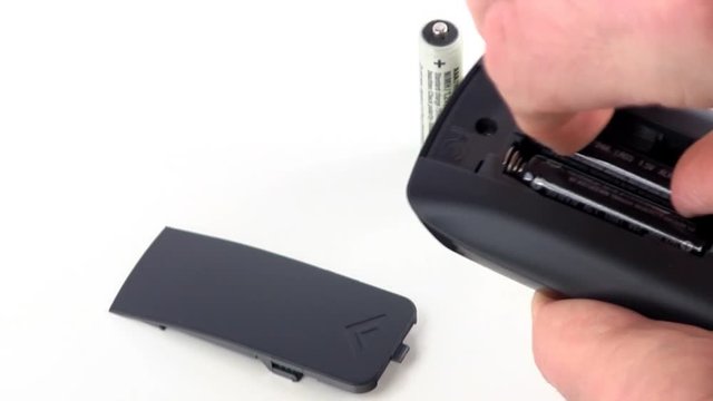AAA batteries being replaced in remote control