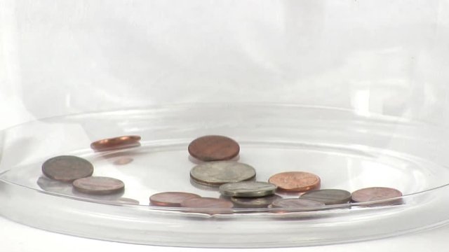 Coins quickly filling a clear container