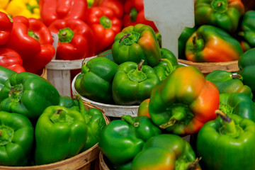 Fresh ripe red sweet bell pepper in box on sale at grocery food store.