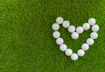 Golf concept : Golf balls arranged as heart symbol.