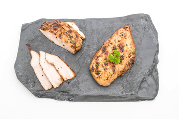 Grilled chicken fillets on slate plate