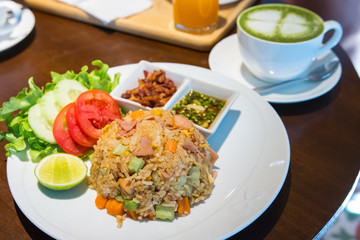 Thai fried rice with ham, crispy bacon and salad