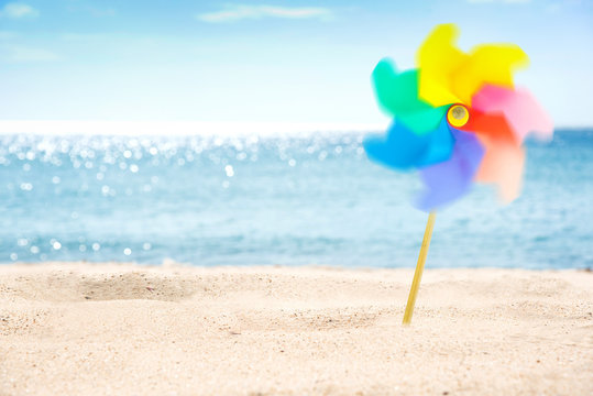 Rotating Colorful Pinwheel On The Beach.