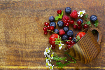 Fototapeta na wymiar Various berries - strawberries, currants, raspberries, blueberries