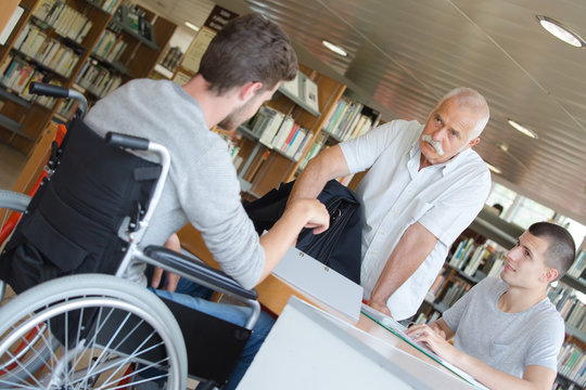 Student in wheelchair in library