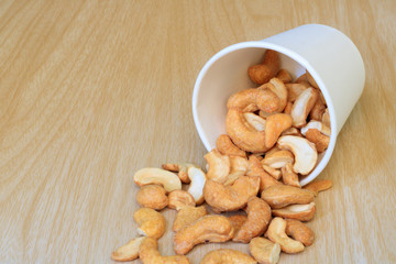 White paper cup filled with the cashew nuts