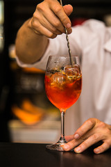 Bartender making a cocktail on bar with fresh fruit.