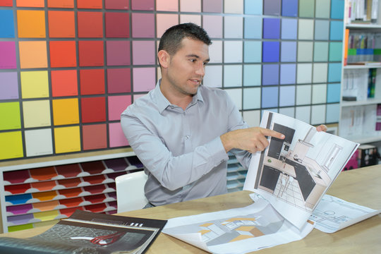interior designer showing customer illustration sketch