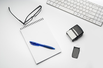Top view of modern, sterile doctors office desk. Medical accessories isolated on a white table background with copy space around products. Photo taken from above.