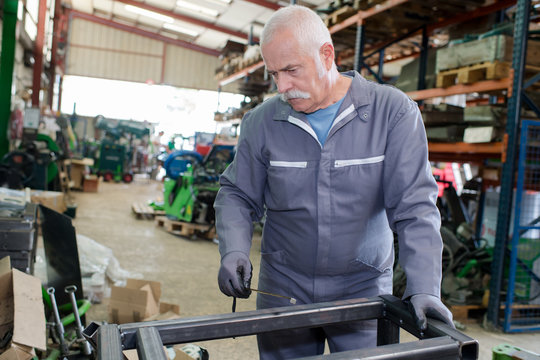 worker assembles profile metal frame