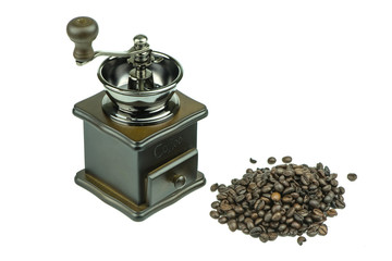 Old coffee grinder and coffee beans on white background.